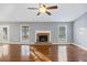 Bright living room with hardwood floors, fireplace, and natural light from large windows at 109 Red Cypress Dr, Goose Creek, SC 29445