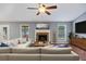 Comfortable living room featuring fireplace, large windows, ceiling fan, and stylish furnishings at 109 Red Cypress Dr, Goose Creek, SC 29445