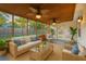 Inviting screened porch with comfortable seating and stylish ceiling fans overlooking fenced backyard at 109 Red Cypress Dr, Goose Creek, SC 29445