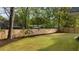 Spacious backyard with lush green grass, mature trees, and privacy fence at 1106 Meadowcroft Ln, Mount Pleasant, SC 29464