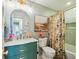Stylish bathroom featuring a marble countertop, decorative mirror, and floral shower curtain at 1106 Meadowcroft Ln, Mount Pleasant, SC 29464