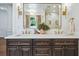 Bathroom featuring double sinks, ample storage, and decorative mirrors at 1106 Meadowcroft Ln, Mount Pleasant, SC 29464