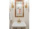 Stylish bathroom featuring a pedestal sink, decorative mirror, and sconce lighting at 1106 Meadowcroft Ln, Mount Pleasant, SC 29464