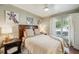 Cozy bedroom features a large window, neutral walls, hardwood floors, and elegant decor at 1106 Meadowcroft Ln, Mount Pleasant, SC 29464