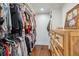 Organized walk-in closet with shelving, hanging rods, wood floors, and chest of drawers at 1106 Meadowcroft Ln, Mount Pleasant, SC 29464