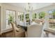 Bright dining room with a round table, chairs and many large windows at 1106 Meadowcroft Ln, Mount Pleasant, SC 29464