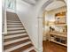 Inviting entryway with stairs, hardwood floors, console table, lamp, and decorative items at 1106 Meadowcroft Ln, Mount Pleasant, SC 29464