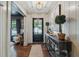 Inviting entryway featuring hardwood floors, paneled walls, and a stylish console table with decor at 1106 Meadowcroft Ln, Mount Pleasant, SC 29464