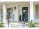 A welcoming front porch featuring elegant columns and decorative accents at the entry of the home at 1106 Meadowcroft Ln, Mount Pleasant, SC 29464