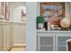 Hallway nook featuring decorative cabinet with artwork and greenery adding charm to the space at 1106 Meadowcroft Ln, Mount Pleasant, SC 29464