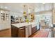 Open-concept kitchen with large island, farmhouse sink, and seamless flow to living and dining areas at 1106 Meadowcroft Ln, Mount Pleasant, SC 29464