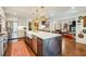 Open concept kitchen with stainless appliances, island and view to the living room at 1106 Meadowcroft Ln, Mount Pleasant, SC 29464