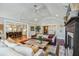 Open-concept living room flowing into a modern kitchen, featuring vaulted ceilings and a cozy fireplace at 1106 Meadowcroft Ln, Mount Pleasant, SC 29464