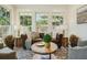 Comfortable living room with a leather sofa, armchairs, and large windows at 1106 Meadowcroft Ln, Mount Pleasant, SC 29464