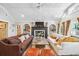 Bright living room with vaulted ceilings, fireplace, comfortable seating, and natural light from the large windows at 1106 Meadowcroft Ln, Mount Pleasant, SC 29464