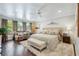 Spacious main bedroom with a plush bed, sitting area, ceiling fan, and ample natural light at 1106 Meadowcroft Ln, Mount Pleasant, SC 29464