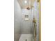 Sleek shower featuring gray subway tile, glass enclosure, and brass fixtures at 1106 Meadowcroft Ln, Mount Pleasant, SC 29464