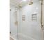 Bright shower with dual heads, tiled walls, glass surround, and built-in shelving at 1106 Meadowcroft Ln, Mount Pleasant, SC 29464