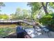 Outdoor patio with comfortable seating, serene green lawn with bridge to water access at 1136 Shadow Lake Cir # 54, Mount Pleasant, SC 29464