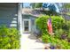 Charming home entrance featuring a decorative door, lush greenery, and a welcoming American flag, offering curb appeal at 1136 Shadow Lake Cir # 54, Mount Pleasant, SC 29464