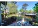 Relaxing patio area with seating overlooking a peaceful pond, trees and surrounding greenery at 1136 Shadow Lake Cir # 54, Mount Pleasant, SC 29464