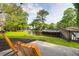 Relax on the patio with views of lush landscaping, serene pond, and wooden boardwalk at 1136 Shadow Lake Cir, Mount Pleasant, SC 29464