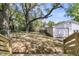 View of the backyard featuring large trees and a detached garage at 1142 Camden St, North Charleston, SC 29405