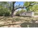 Spacious backyard with a detached garage and lush greenery for outdoor enjoyment at 1142 Camden St, North Charleston, SC 29405