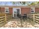 Outdoor deck with table and chairs with a brick home exterior at 1142 Camden St, North Charleston, SC 29405