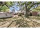 Extensive backyard showcasing the detached garage, fire pit, and mature trees at 1142 Camden St, North Charleston, SC 29405