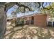 Brick home exterior featuring a private backyard with mature trees at 1142 Camden St, North Charleston, SC 29405