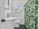 Bright bathroom features white tile and a green shower curtain at 1142 Camden St, North Charleston, SC 29405