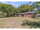 Attractive brick home with mature trees, a well-kept lawn, and a welcoming exterior at 1142 Camden St, North Charleston, SC 29405