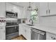 Well-lit kitchen with white cabinetry, stainless appliances, and subway tile backsplash at 1142 Camden St, North Charleston, SC 29405