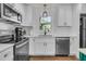 Bright kitchen with white cabinets, stainless steel appliances, and hardwood floors at 1142 Camden St, North Charleston, SC 29405