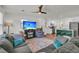 Spacious living area with an open layout, featuring a TV, kitchen and hardwood flooring at 1142 Camden St, North Charleston, SC 29405