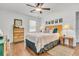 Comfortable main bedroom with stylish decor, hardwood floors, and ceiling fan at 1142 Camden St, North Charleston, SC 29405