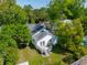 Aerial view of backyard featuring a deck with seating area, mature trees, and outdoor living spaces at 115 Peachtree St, Charleston, SC 29403