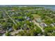 Overhead view of neighborhood with tree-lined streets, community garden, and nearby waterfront at 115 Peachtree St, Charleston, SC 29403