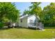 The spacious backyard has a deck, a golf cart, and plenty of green space to enjoy at 115 Peachtree St, Charleston, SC 29403