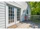 Backyard shows french door, a red chair on a small deck with a view of trees and sky at 115 Peachtree St, Charleston, SC 29403