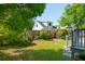 Private backyard features a wooden fence, mature trees, and a patio area with greenery at 115 Peachtree St, Charleston, SC 29403