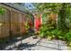 Relaxing backyard with stone patio, comfortable chairs, and a climbing shade structure at 115 Peachtree St, Charleston, SC 29403