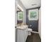 Bathroom with granite countertop vanity, blue accent wall, and natural light from the window at 115 Peachtree St, Charleston, SC 29403