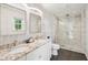 Modern bathroom with double vanity, marble countertops, and a glass-enclosed shower at 115 Peachtree St, Charleston, SC 29403
