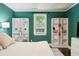 Bedroom with green walls, hardwood floors, white shelving, and a window with natural light at 115 Peachtree St, Charleston, SC 29403