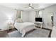 Cozy bedroom features hardwood floors, area rug, ceiling fan, and natural light from two windows at 115 Peachtree St, Charleston, SC 29403