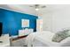 Bright bedroom with hardwood floors, white walls, and accent wall, with TV and stylish desk at 115 Peachtree St, Charleston, SC 29403