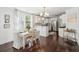 Bright dining area featuring white table and chairs, wood floors, and elegant decor in a modern setting at 115 Peachtree St, Charleston, SC 29403