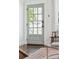 Elegant entryway featuring a stylish glass-paneled door, hardwood floors, and a decorative area rug at 115 Peachtree St, Charleston, SC 29403